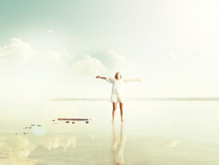 A woman walking joyfully on reflective water