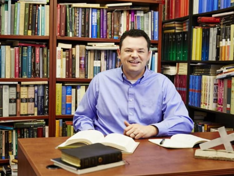 A man sitting in a library