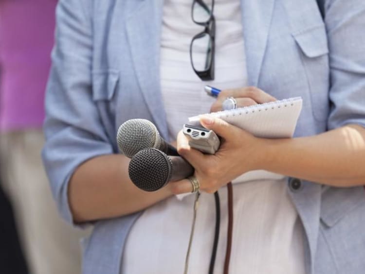 journalist writing things down