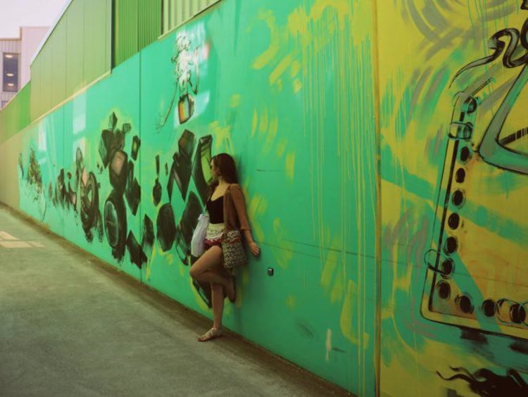 Kate in front of a street art mural