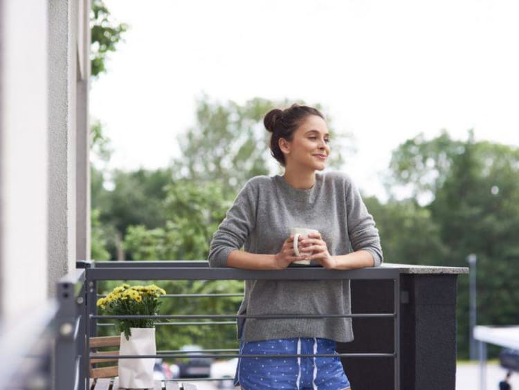 a woman outside with coffee in the morning