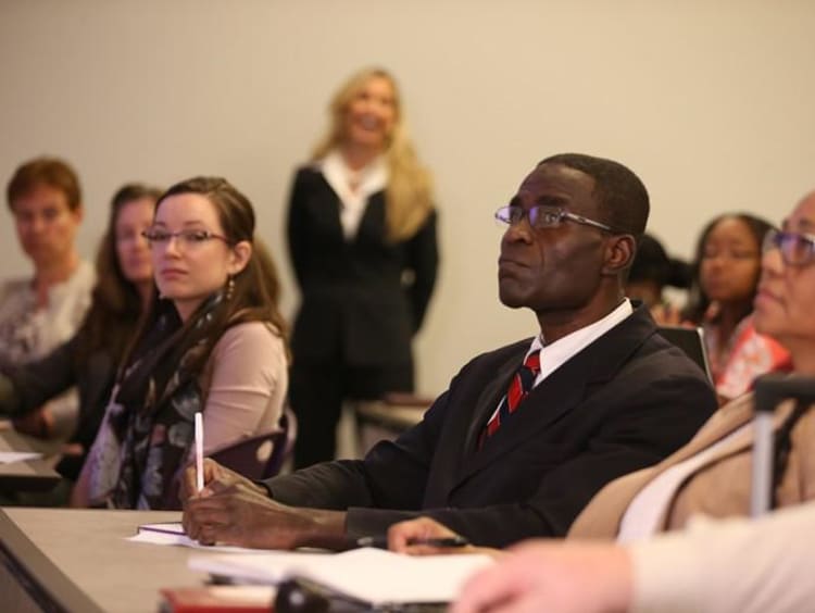 group of doctoral students in a classroom