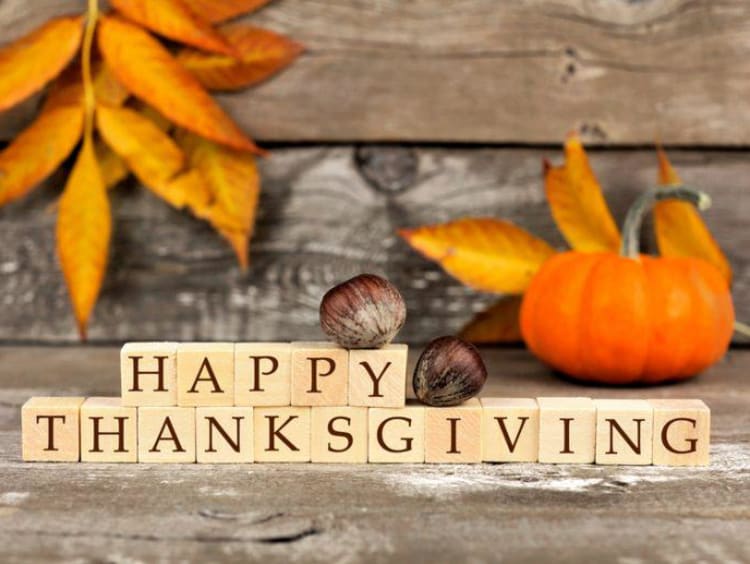 A "Happy Thanksgiving" sign with autumn leaves 