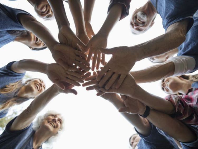 Students piling their hands between them