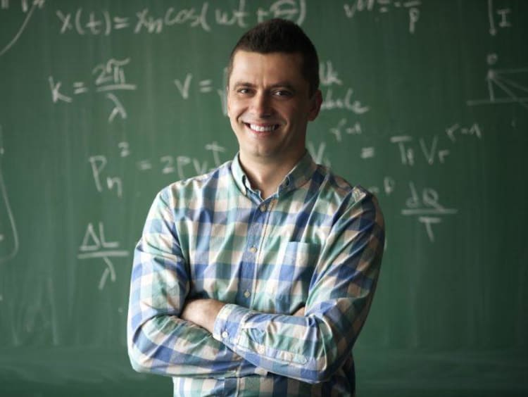 Man standing in front a chalkboard