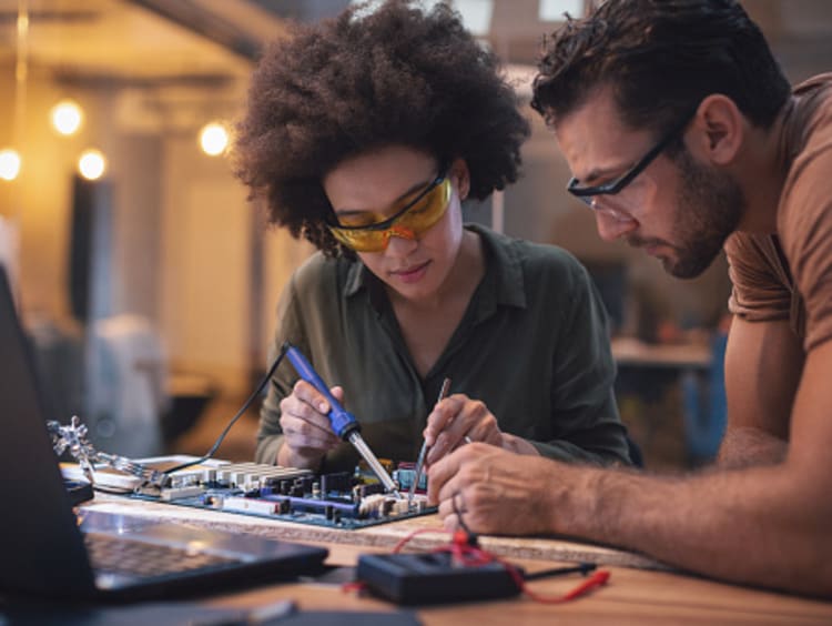 Female and male electrical engineers designing and developing electrical systems