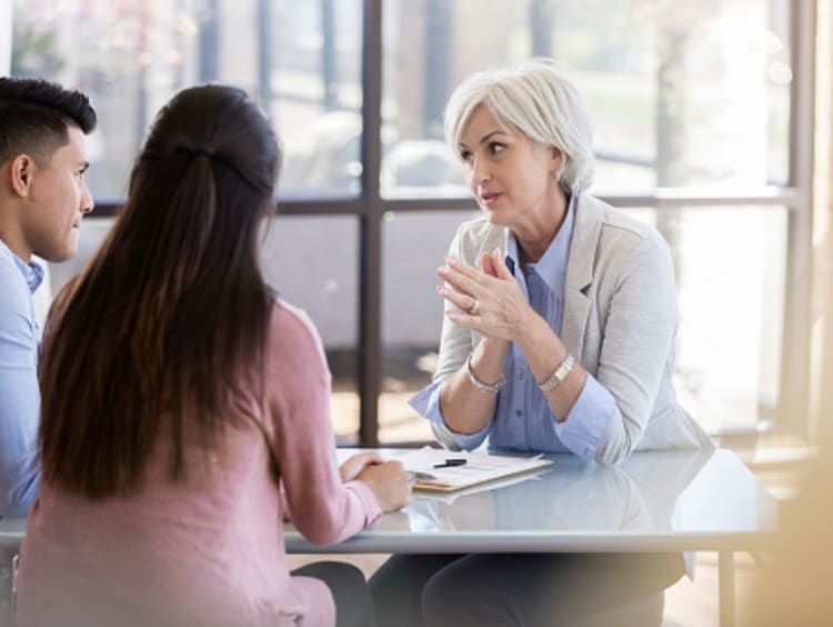 Female psychologist speaks with a young couple