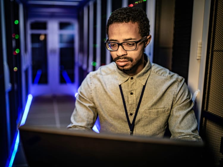 Cybersecurity manager checking system networks in computer lab