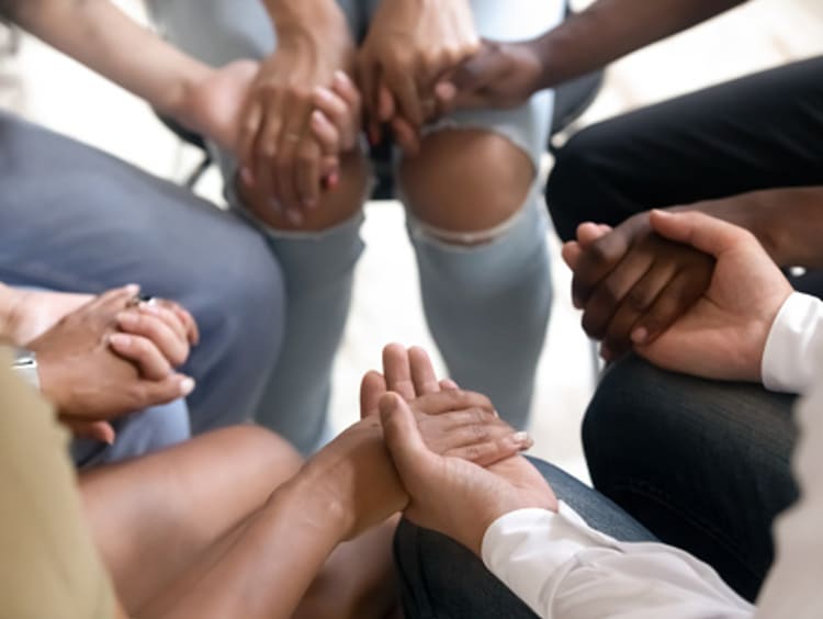 People in circle praying knowing every job is important