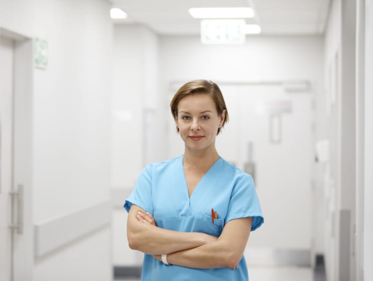 GCU graduate ABSN nurse standing in hospital hallway