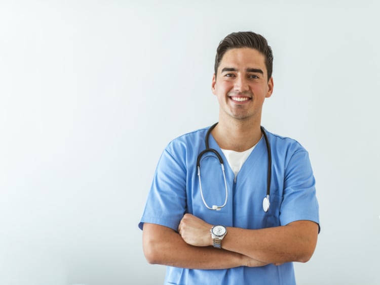 A physician's assistant smiles at the camera