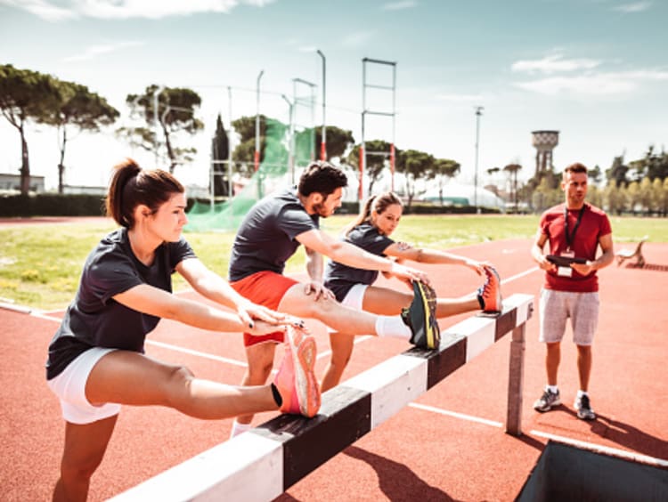 threes students stretching and working out in college