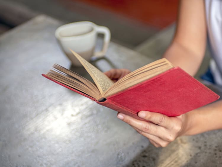 Woman reads a book written by a long-dead author