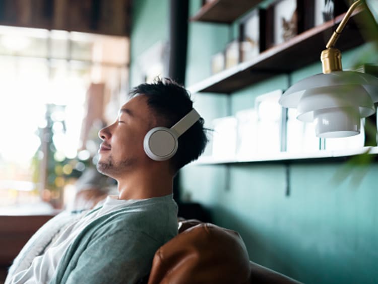 man improving spiritual health by listening to the Bible