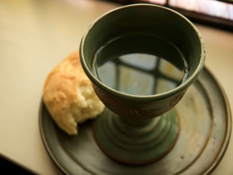 Communion bread and wine sitting on a window sill