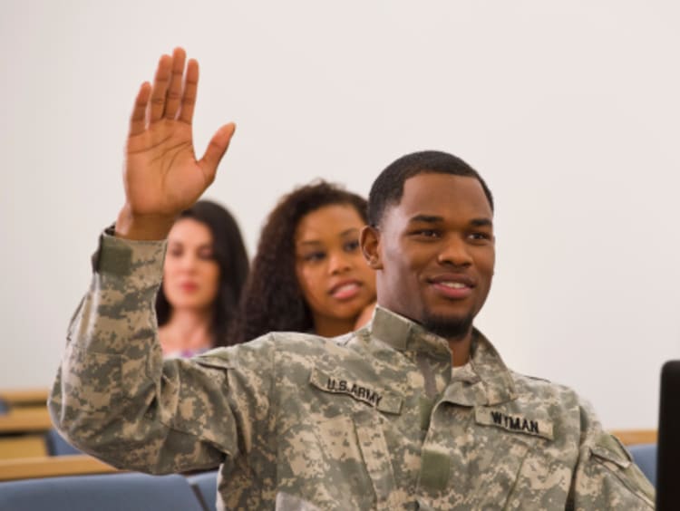 service member in classroom asking a question