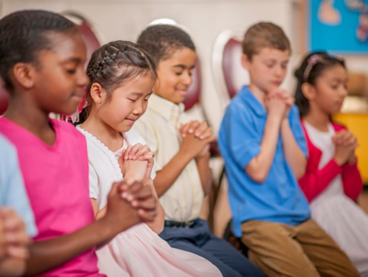 kids praying in transformed communities