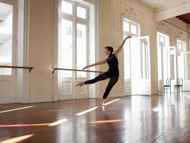 Female dance student practicing technique in studio