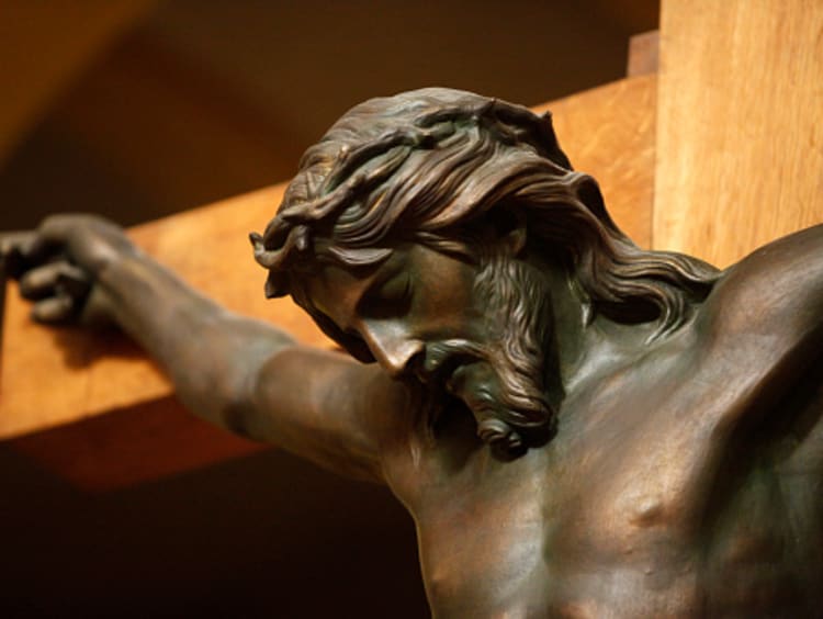 Statue of Jesus on the cross showing love endures