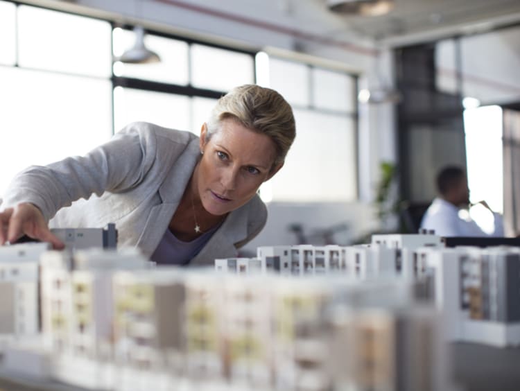 Urban planner examines a city model