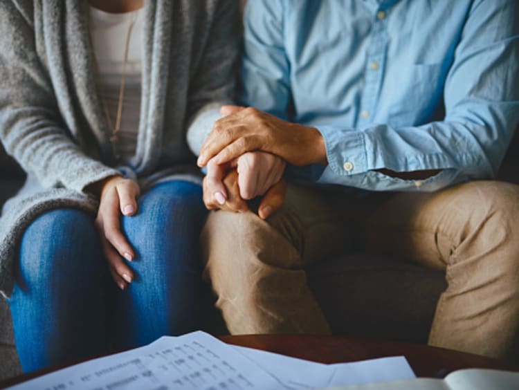 couple showing love and forgiveness by holding hands