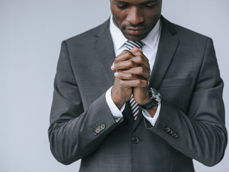 businessman praying God to help find meaning in life