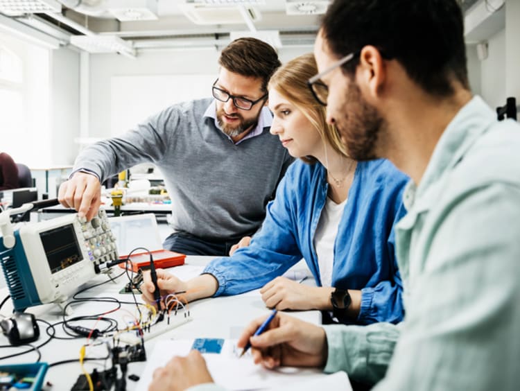 three students building STEM project