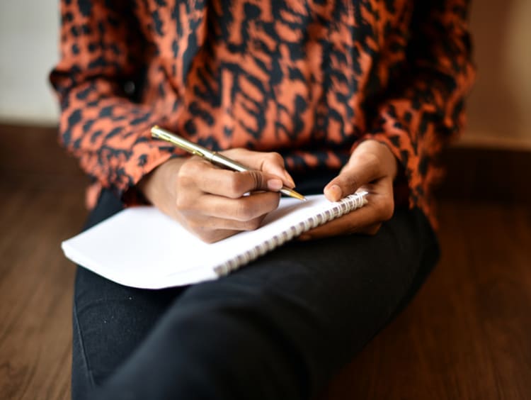 woman writing on notebook