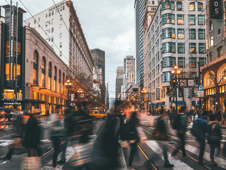 people walking quickly in a city