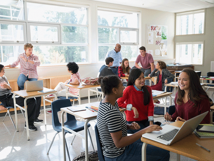 Classroom full of students in different discussion groups