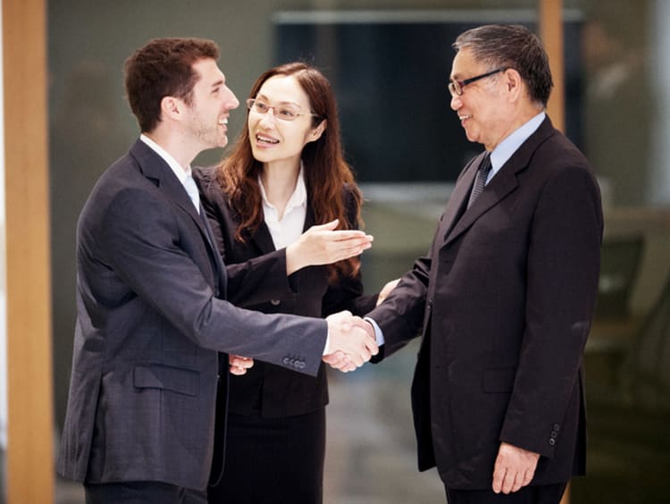 woman translator introducing two businessmen