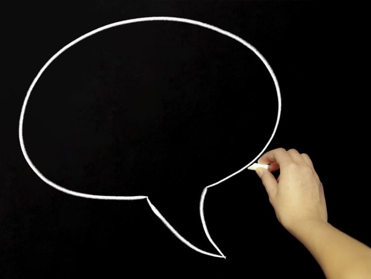 Speech bubble drawn with chalk on a black board