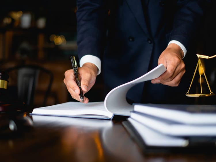 Compliance officer taking notes in an office