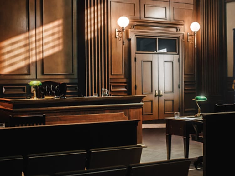 Image of an empty, dimly lit courtroom