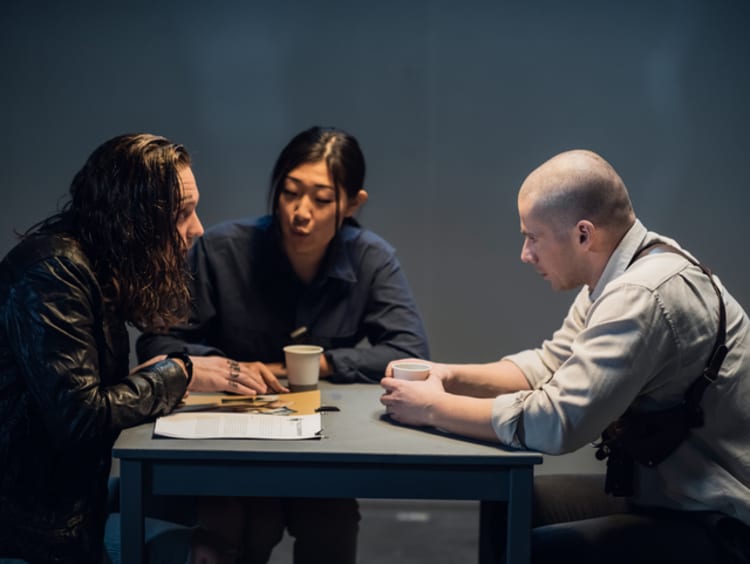 Two officers interrogating suspect