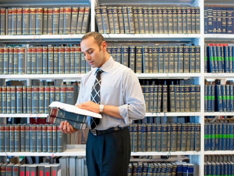 Man reading legal text in law library