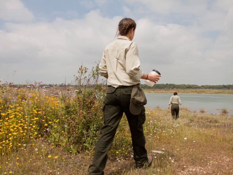 Two game wardens patrolling a river