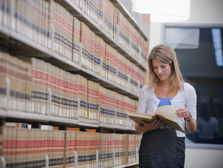 law student reading in library