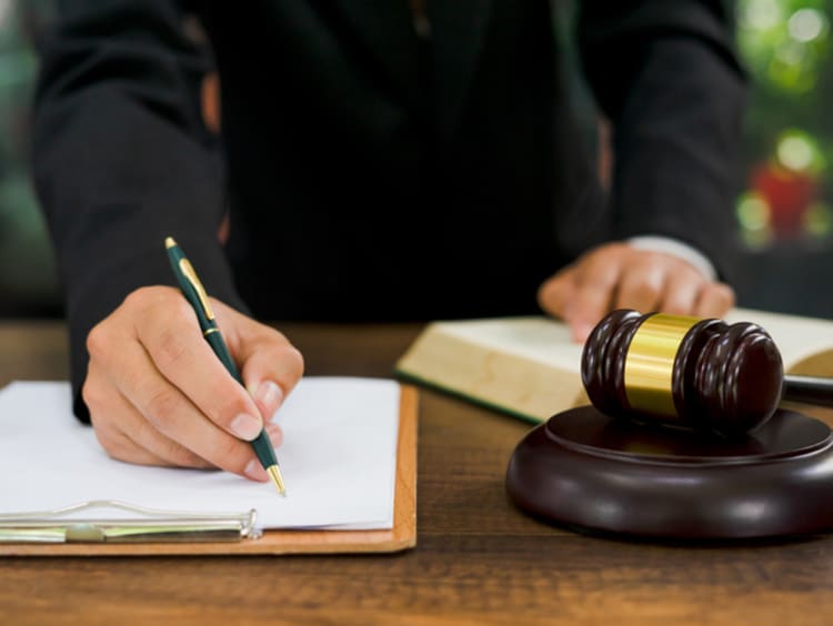 judge taking notes during court case