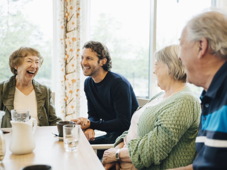 social worker and clients laughing at a table