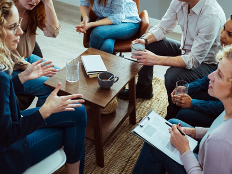 Addiction counselor leading group therapy session