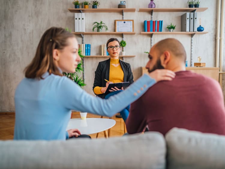 Couple discussing substance abuse recovery with counselor