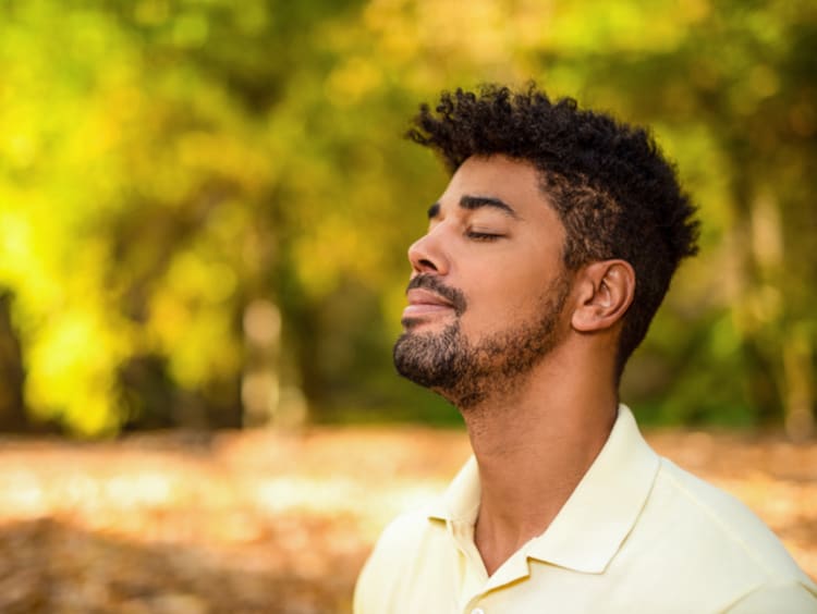 A man meditating outdoors