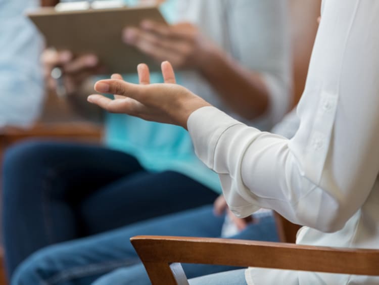 Person gesturing in therapy session