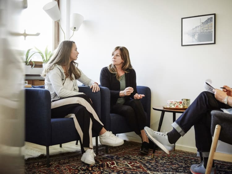 Mother and daughter speaking with psychologist