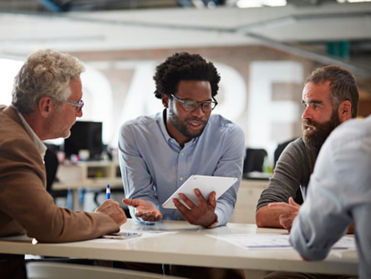 Business operations manager discussing strategy with team