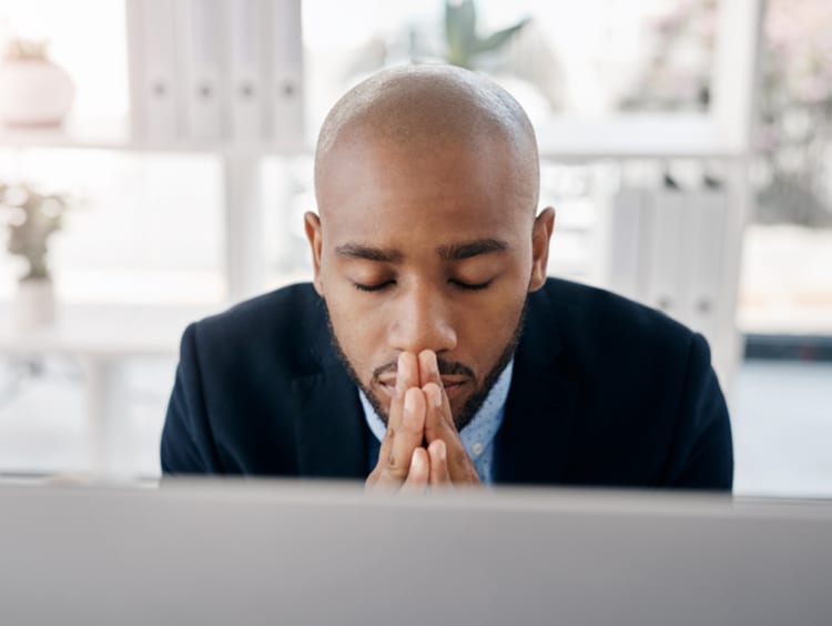 Businessman praying in office