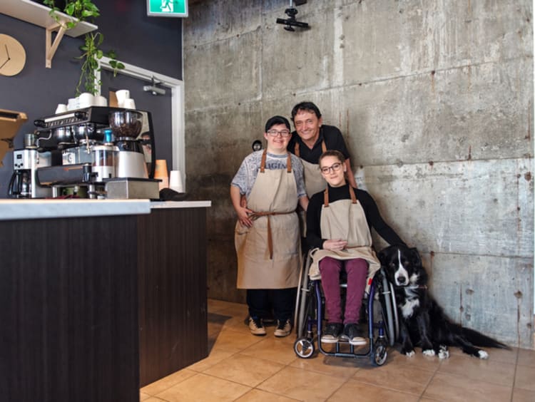 Three employees at coffee shop with conscious company culture