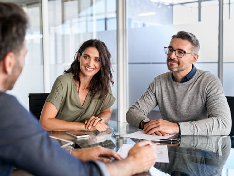 Credit analyst meeting with a couple in an office