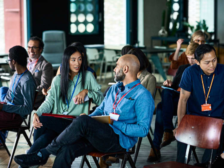 Diverse coworkers chatting during a work meeting